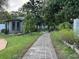 Stone walkway leads to charming backyard shed at 825 E Lakeshore Blvd, Kissimmee, FL 34744