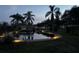 Peaceful backyard pond with bridge and lighting at night at 825 E Lakeshore Blvd, Kissimmee, FL 34744