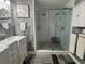 Elegant bathroom with a walk-in shower, marble vanity, and patterned wallpaper at 825 E Lakeshore Blvd, Kissimmee, FL 34744