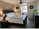 Main bedroom with a king-size bed, dark wood furniture, and a window seat at 825 E Lakeshore Blvd, Kissimmee, FL 34744