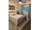 Cozy bedroom with white bedding, black metal bed frame, and gray curtains at 825 E Lakeshore Blvd, Kissimmee, FL 34744