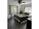 Bedroom with dark green bedding, ceiling fan, and two windows at 825 E Lakeshore Blvd, Kissimmee, FL 34744