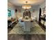 Elegant dining room with large table, chandelier, and green rug at 825 E Lakeshore Blvd, Kissimmee, FL 34744