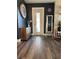 Bright entryway with dark walls, wood flooring, and a full-length mirror at 825 E Lakeshore Blvd, Kissimmee, FL 34744