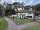 Yellow house exterior with brick patio and walkway at 825 E Lakeshore Blvd, Kissimmee, FL 34744