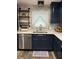 Modern kitchen features stainless steel appliances and dark blue cabinetry at 825 E Lakeshore Blvd, Kissimmee, FL 34744
