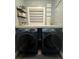 Laundry room with side-by-side washer and dryer, and a stacked shelf at 825 E Lakeshore Blvd, Kissimmee, FL 34744