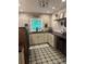 Bright laundry room features stylish cabinets, patterned flooring, and a stone accent wall at 825 E Lakeshore Blvd, Kissimmee, FL 34744