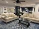 Open living room with neutral sofas and a view into the kitchen at 825 E Lakeshore Blvd, Kissimmee, FL 34744