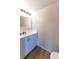Bathroom with white vanity, mirror, and wood-look floors at 945 Gateshead Ct, Kissimmee, FL 34758