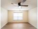 Simple bedroom with wood-look floors and ceiling fan at 945 Gateshead Ct, Kissimmee, FL 34758