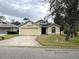 One-story house with a two-car garage and a well-maintained lawn at 1005 Tequesta Trl, Lake Wales, FL 33898