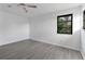 Simple bedroom with grey vinyl flooring and a ceiling fan at 10420 Vista Del Sol Cir, Clermont, FL 34711