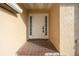 Front entrance with a white door and tiled flooring at 10420 Vista Del Sol Cir, Clermont, FL 34711