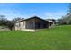 House exterior showcasing a screened patio and well-maintained lawn at 10420 Vista Del Sol Cir, Clermont, FL 34711