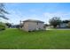 Tan two-story house with a large grassy yard at 10420 Vista Del Sol Cir, Clermont, FL 34711