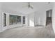 Bright living room featuring hardwood floors and large windows at 10420 Vista Del Sol Cir, Clermont, FL 34711