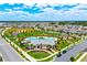 Aerial view of the community featuring a large pool and clubhouse with lush landscaping at 11120 Robert Frost Dr, Winter Garden, FL 34787