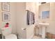 Small bathroom with pedestal sink, toilet and decorative accents at 11120 Robert Frost Dr, Winter Garden, FL 34787
