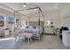 Main bedroom with canopy bed, ceiling fan, and plenty of natural light at 11120 Robert Frost Dr, Winter Garden, FL 34787