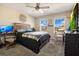 Bright bedroom with a comfortable bed and a workspace at 11120 Robert Frost Dr, Winter Garden, FL 34787