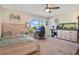 Bedroom with a large bed, desk, and aquarium at 11120 Robert Frost Dr, Winter Garden, FL 34787