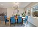 Bright dining room with a wooden table and blue chairs, near kitchen at 11120 Robert Frost Dr, Winter Garden, FL 34787