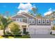 Two-story home with gray siding, white trim, and a three-car garage at 11120 Robert Frost Dr, Winter Garden, FL 34787