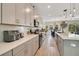 Open concept kitchen with light gray cabinets and quartz countertops at 11120 Robert Frost Dr, Winter Garden, FL 34787