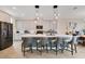 Modern kitchen with white cabinets, a large island, and stainless steel appliances at 11120 Robert Frost Dr, Winter Garden, FL 34787