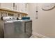Laundry room with washer, dryer, and ample storage at 11120 Robert Frost Dr, Winter Garden, FL 34787