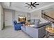 Spacious living room with large windows, hardwood floors, and a fireplace at 11120 Robert Frost Dr, Winter Garden, FL 34787