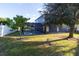 Spacious backyard with a large tree and fenced perimeter at 1161 Kempton Chase Pkwy, Orlando, FL 32837