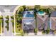Aerial view of two homes with solar panels and pools at 16548 Raven Rock Pl, Winter Garden, FL 34787
