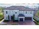 Two-story house with gray exterior, brown roof, and a two-car garage at 16548 Raven Rock Pl, Winter Garden, FL 34787