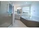 Modern bathroom with soaking tub and walk-in shower at 16548 Raven Rock Pl, Winter Garden, FL 34787