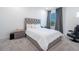 Bedroom with a queen-size bed and large window at 16548 Raven Rock Pl, Winter Garden, FL 34787