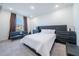 Bedroom with a queen-size bed and a small sofa at 16548 Raven Rock Pl, Winter Garden, FL 34787