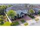 Two-story home with tile roof, palm trees, and double garage at 16548 Raven Rock Pl, Winter Garden, FL 34787
