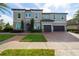 Two-story house with gray exterior, stone accents, and a two-car garage at 16548 Raven Rock Pl, Winter Garden, FL 34787