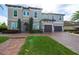 Two-story house with gray exterior, stone accents, and a two-car garage at 16548 Raven Rock Pl, Winter Garden, FL 34787