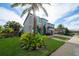 House with gray exterior, stone accents, and a two-car garage at 16548 Raven Rock Pl, Winter Garden, FL 34787