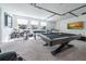 Game room with pool table, bar, and entertainment at 16548 Raven Rock Pl, Winter Garden, FL 34787