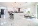 Open concept kitchen with white cabinets, center island, and breakfast nook at 16548 Raven Rock Pl, Winter Garden, FL 34787