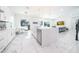 Modern kitchen with white cabinets, marble floors, and stainless steel appliances at 16548 Raven Rock Pl, Winter Garden, FL 34787