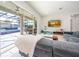 Spacious living room with grey sectional sofa and views of the pool at 16548 Raven Rock Pl, Winter Garden, FL 34787