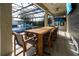 Covered patio with large dining table and pool view at 16548 Raven Rock Pl, Winter Garden, FL 34787