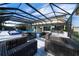 Relaxing poolside patio with wicker furniture under a covered lanai at 16548 Raven Rock Pl, Winter Garden, FL 34787