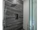 Modern shower with gray tile and glass enclosure at 16548 Raven Rock Pl, Winter Garden, FL 34787