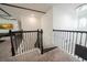 Elegant staircase with black iron railings and carpeting at 16548 Raven Rock Pl, Winter Garden, FL 34787